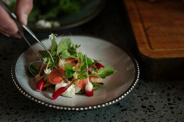 Male chef preparing salad in restaurant kitchen
