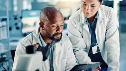 Science, people and discussion with tablet in lab for medical research, vaccine report and review. Scientist, teamwork and reading results for pharmaceutical development, biotech study and innovation