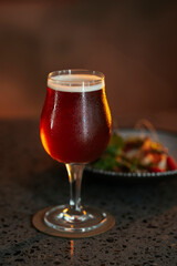 A glass of beer and a salad in a restaurant setting