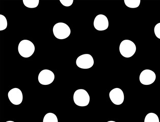 Seamless hand-drawn white polka dot pattern on black background. Modern and playful texture ideal for textile prints, wrapping paper, packaging, branding, digital design, and backgrounds.