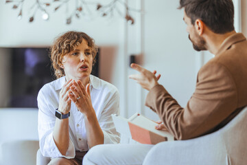 Two Individuals Engaged in a Serious Conversation in a Cozy Setting