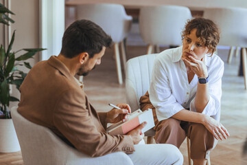 Counselor and Client Discussing Concerns in a Serene Office Setting