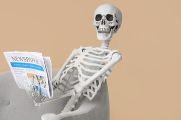 Skeleton with newspaper sitting on armchair near beige wall in living room