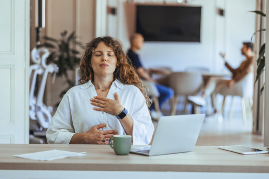 Woman Practicing Relaxation and Mindfulness in a Modern Workplace Setting - Powered by Adobe