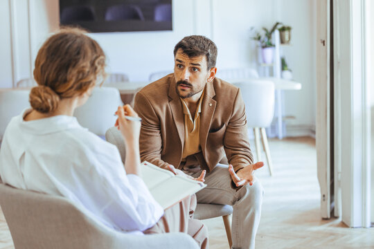 Man Engaged in Conversation During a Professional Counseling or Therapy Session