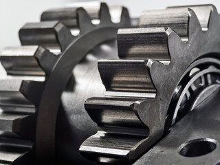 Close-up view of metal gears in a mechanical assembly showcasing precision engineering and design in a workshop environment