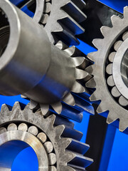 Close-up view of metal gears in a mechanical assembly showcasing precision engineering and design in a workshop environment