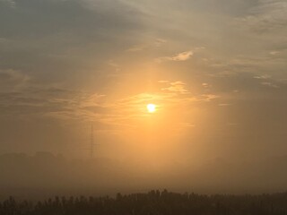 sunrise over the field a misty morning