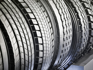 Various tire patterns showcased in a detailed display at an automotive exhibition in a bright showroom