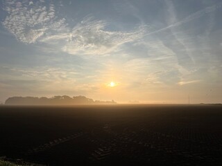 sunrise over the field a foggy morning