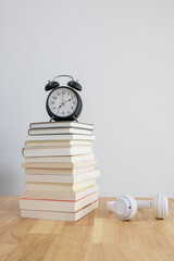 alarm clock and books