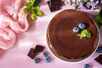 Chocolate cheesecake for breakfast on a pink background. Close-up. View from above.