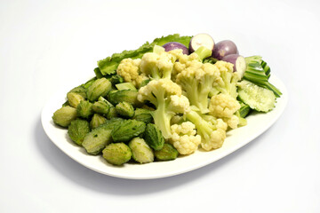Mixed boiled vegetables for eating with chili paste on a white background
