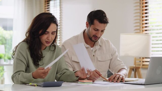 Couple overwhelmed by overdue bills and low income, facing economic stress and inflation-related financial crisis