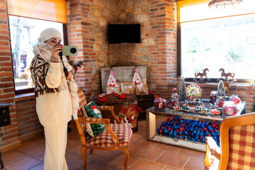 Fototapeta premium Woman filming christmas decoration in rural house in asturias, spain