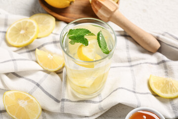 Glass of fresh lemonade with mint on white background, closeup