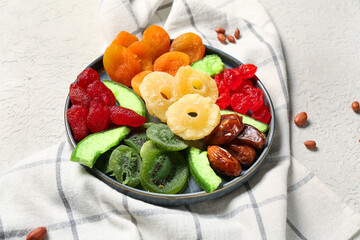 Plate with different candied fruits and peanuts on white background, closeup