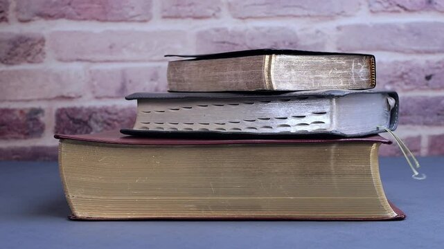 Bible falling for study on gray table in the morning. Preparation for communion and worship concept. Slow motion
