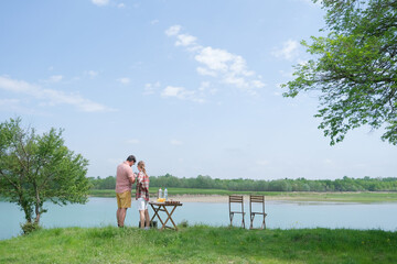 Family on picnic near the lake, looking at view
