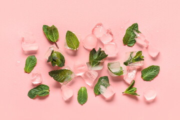 Ice cubes with mint leaves on pink background