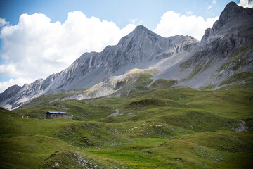 Panoramic alpine view with mountain peaks and lush valley