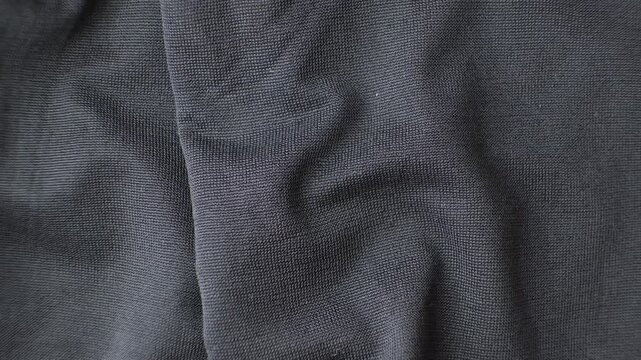 Old worn-out polyester and elastane fabric, pilling and frayed threads.