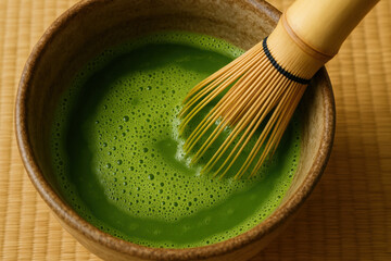 Whisking matcha in traditional bowl creates vibrant green beverage, showcasing rich texture and color of tea. bamboo whisk adds authentic touch to this serene moment