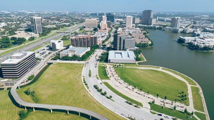 John W. Carpenter Freeway and curved elevated railway, modern cityscape of Las Colinas downtown...