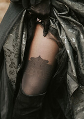 girl's leg in black stockings and black gloves