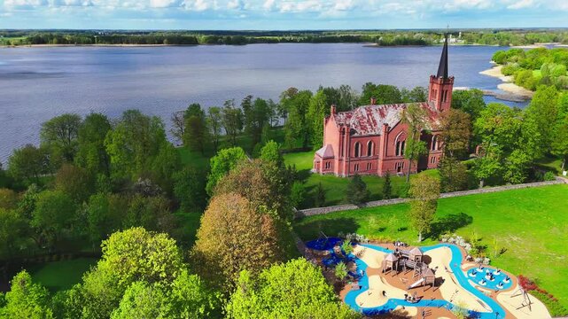 Evangelical Reformed Church And Vaikų žaidimų aik&scaron;telė Playground In Birzai, Lithuania. Aerial Drone Shot