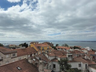 Fototapeta premium Houses, rooftops and river Tejo in Lisbon, Portugal