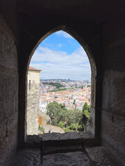 Obraz premium Lisbon rooftops seen through a castle window in Castelo de São Jorge