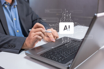 Businessman working on a laptop with artificial intelligence (AI) interface graphics overlayed on...