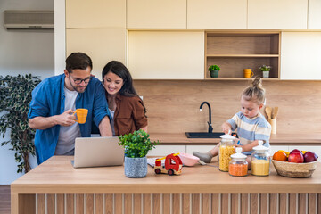 Happy young family with child enjoying new home after moving in – unpacking boxes, relaxing in...
