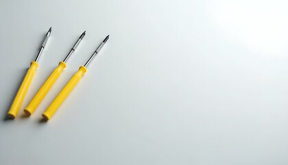 Set of yellow screwdrivers with empty space on a light background, ideal for home repair, electronics, or handyman services