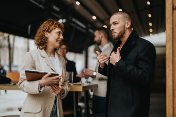 Two business professionals having an engaging conversation outdoors with a modern, casual vibe.