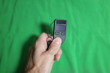 Fingers holding compact cryptocurrency cold storage device