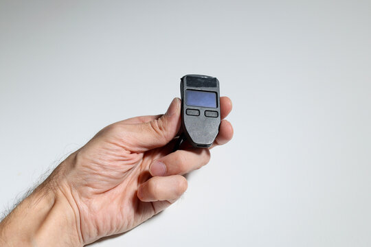 A hand holds a cold crypto wallet, securely storing digital assets offline