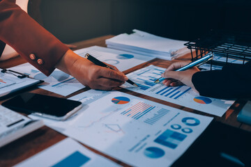 Group of business people brainstorming in analytical plan meeting Calculate the numbers obtained...