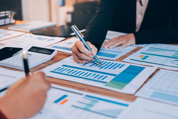 Group of business people brainstorming in analytical plan meeting Calculate the numbers obtained...