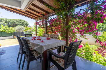 The Terrace of a traditional summer house surrounded by bougainvillea in Turkey