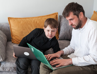 Modern digital classroom with teacher and student using laptops. Learning programming or digital...