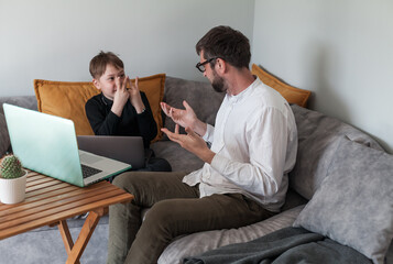 Modern digital classroom with teacher and student using laptops. Learning programming or digital...