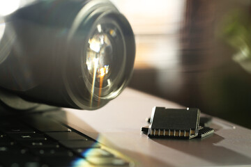 SD memory cards and photo camera on laptop, closeup