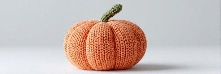 Knitted orange pumpkin, cozy autumn decor, crochet artistry celebrates cozy season, National Yarn Day, imaginative Halloween crafting
