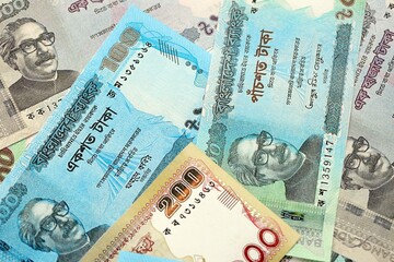 Bangladeshi taka money bills in big amount lies on white color table close up