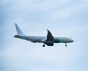 Airplane taking off against cloudy sky