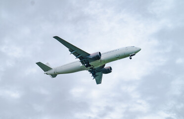 Airplane taking off against cloudy sky