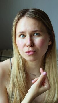 Young woman shows different emotions while making the Gen Z finger heart sign with her index and middle fingers. Expressive and playful mood