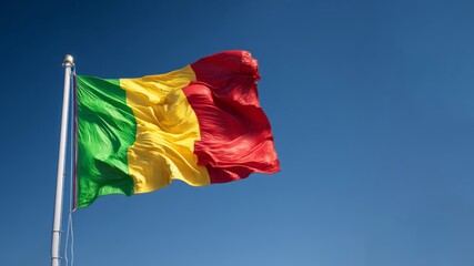 Mali flag waving proudly during independence Day celebration in a clear blue sky